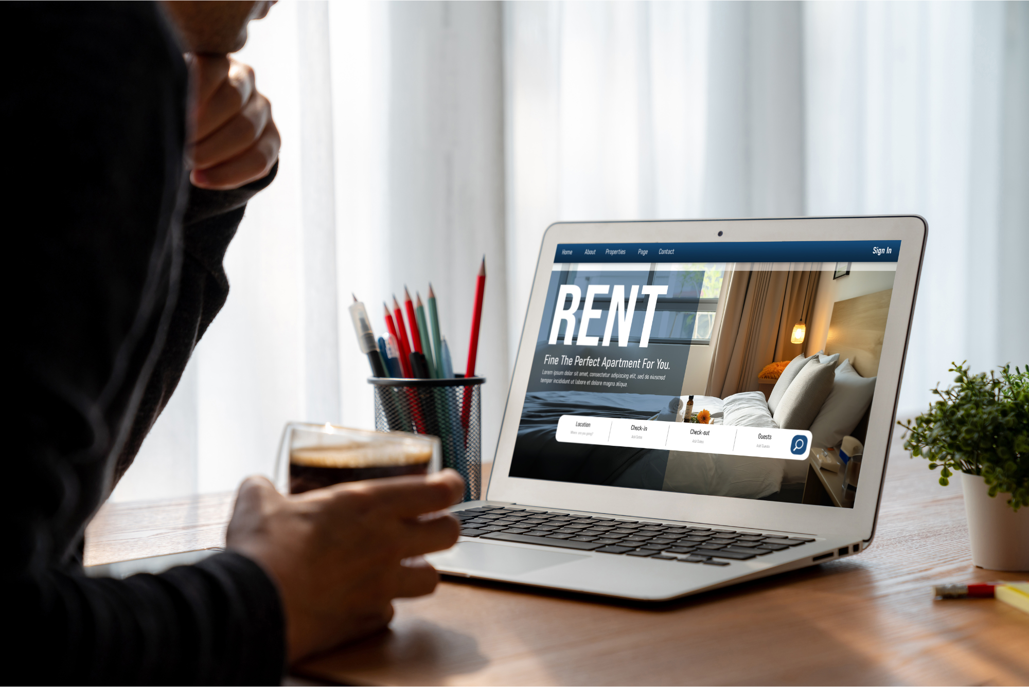 Prospective renter searching laptop for rentals